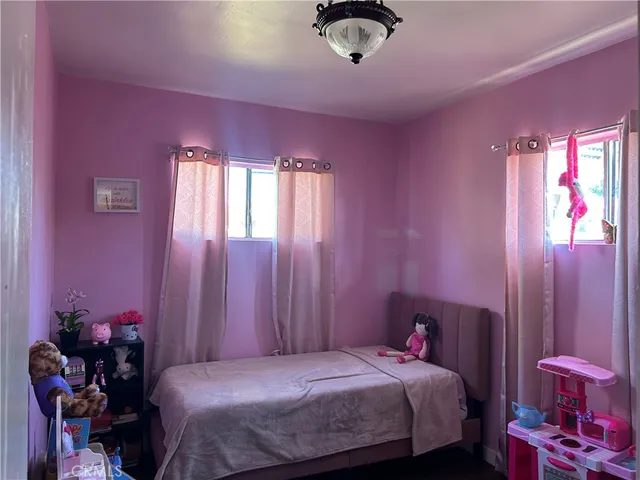 a bedroom with a bed and a chair