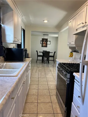 a kitchen with stainless steel appliances a stove a sink and a refrigerator