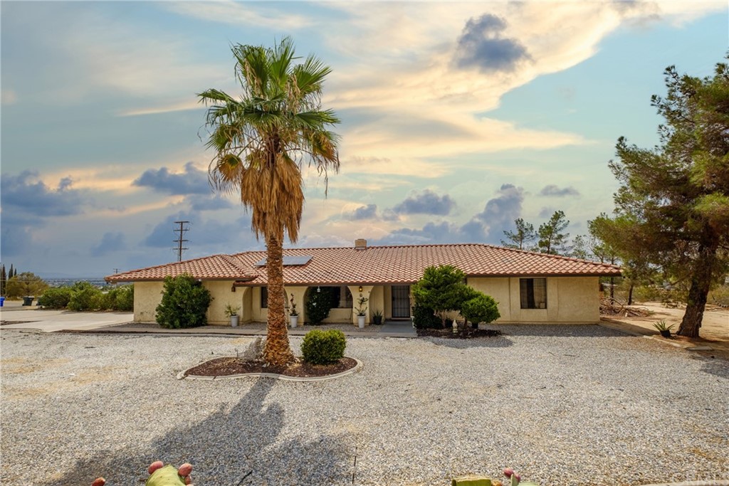 14530 Apple Valley Road Apple Valley, CA 92307 - Photo 1 of 1 a front view of a house with a yard and garage