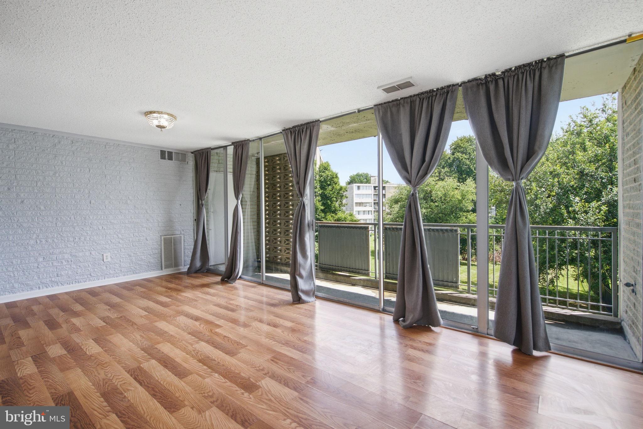1822 Metzerott Road, Unit 103 Hyattsville, MD 20783 - Photo 6 of 25 Living room with direct balcony access
