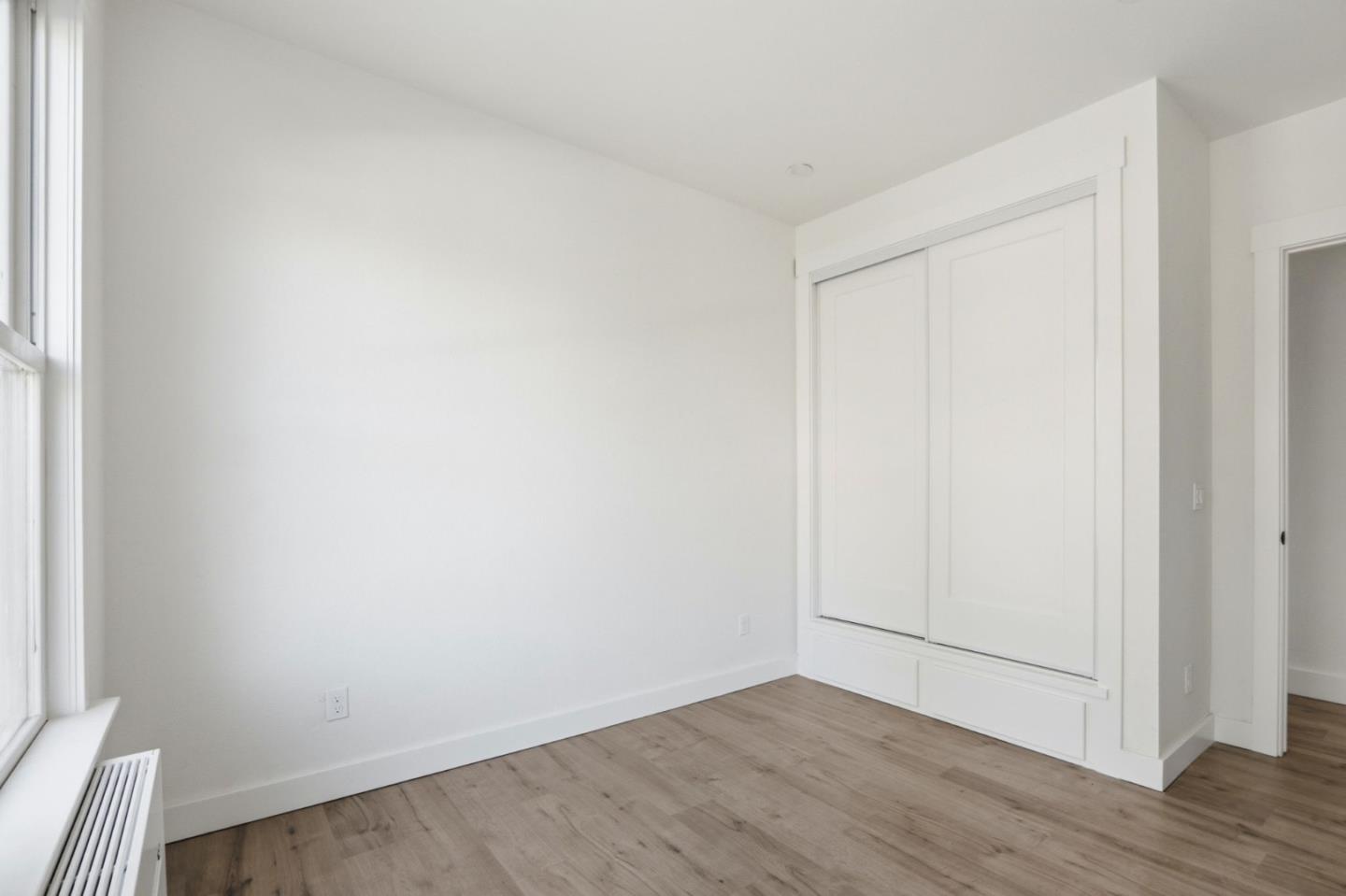 140 East Reed Street, Unit 4 San Jose, CA 95112 - Photo 5 of 9 a view of an empty room with wooden floor