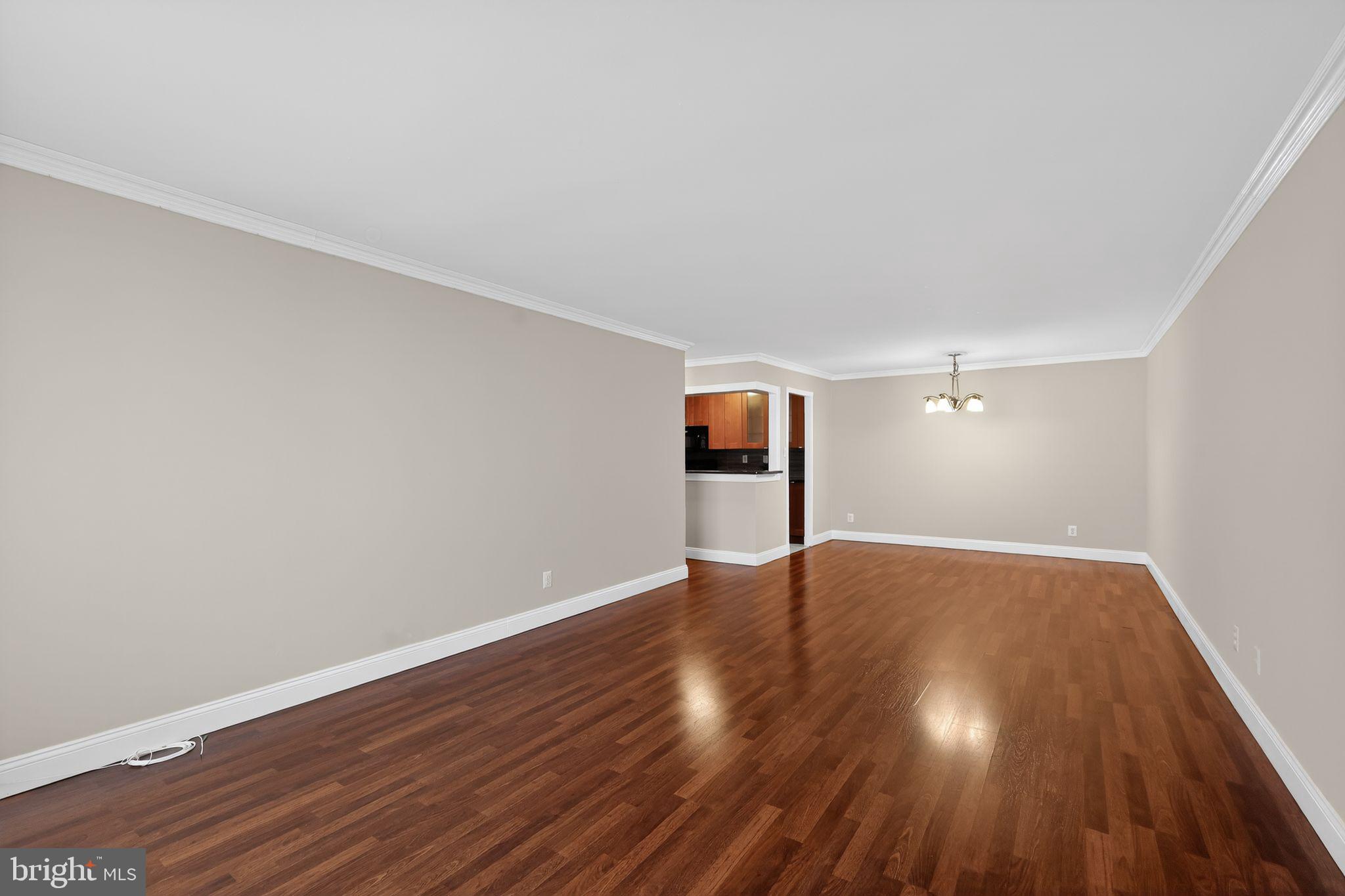 9701 Fields Road, Unit 1904 Gaithersburg, MD 20878 - Photo 11 of 31 a view of an empty room and wooden floor