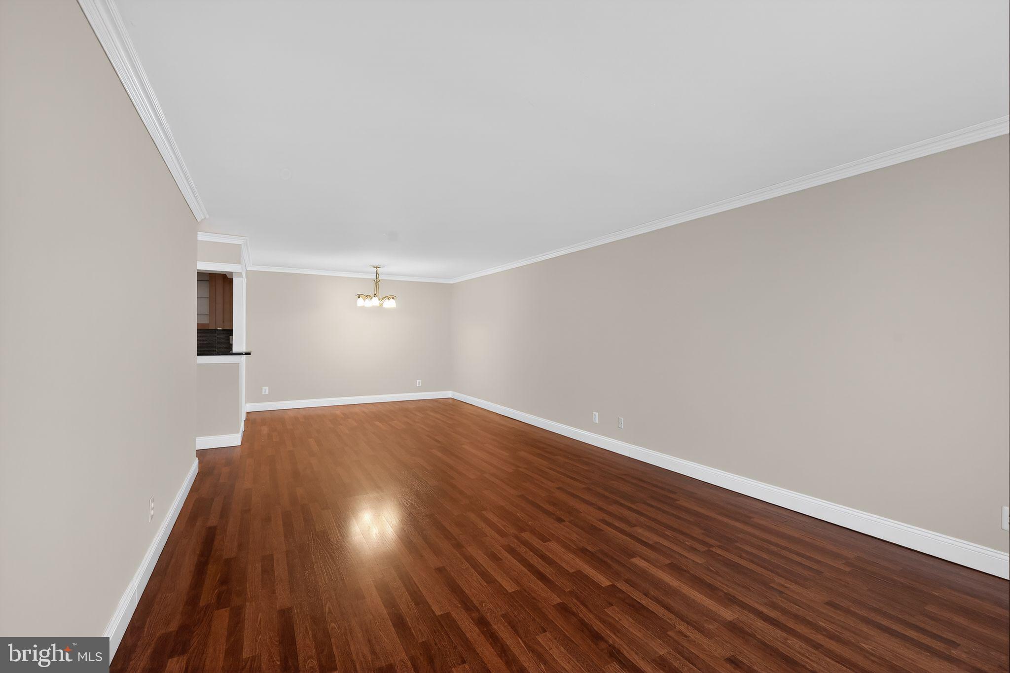 9701 Fields Road, Unit 1904 Gaithersburg, MD 20878 - Photo 12 of 31 a view of an empty room with wooden floor