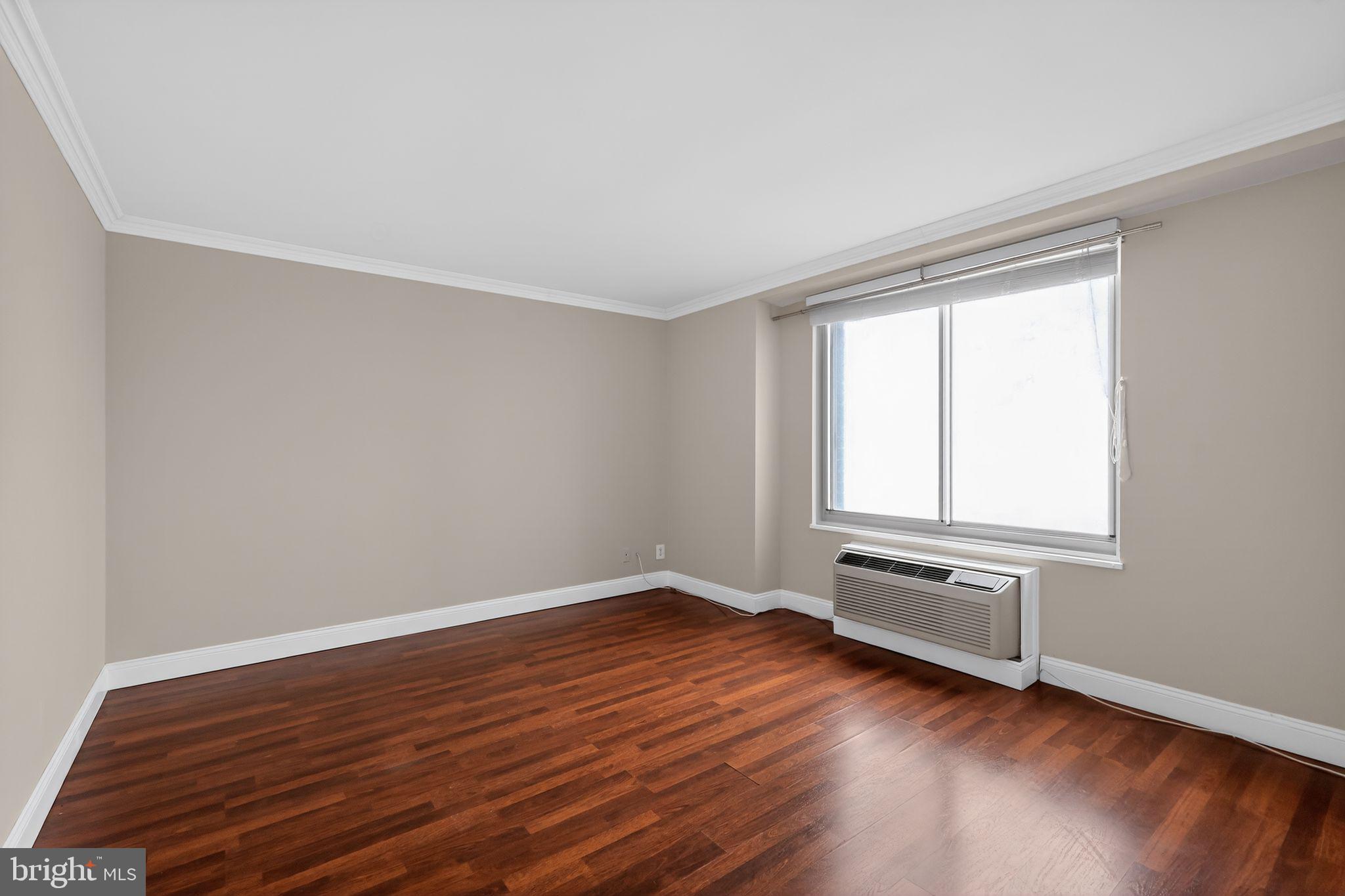 9701 Fields Road, Unit 1904 Gaithersburg, MD 20878 - Photo 15 of 31 an empty room with wooden floor and windows