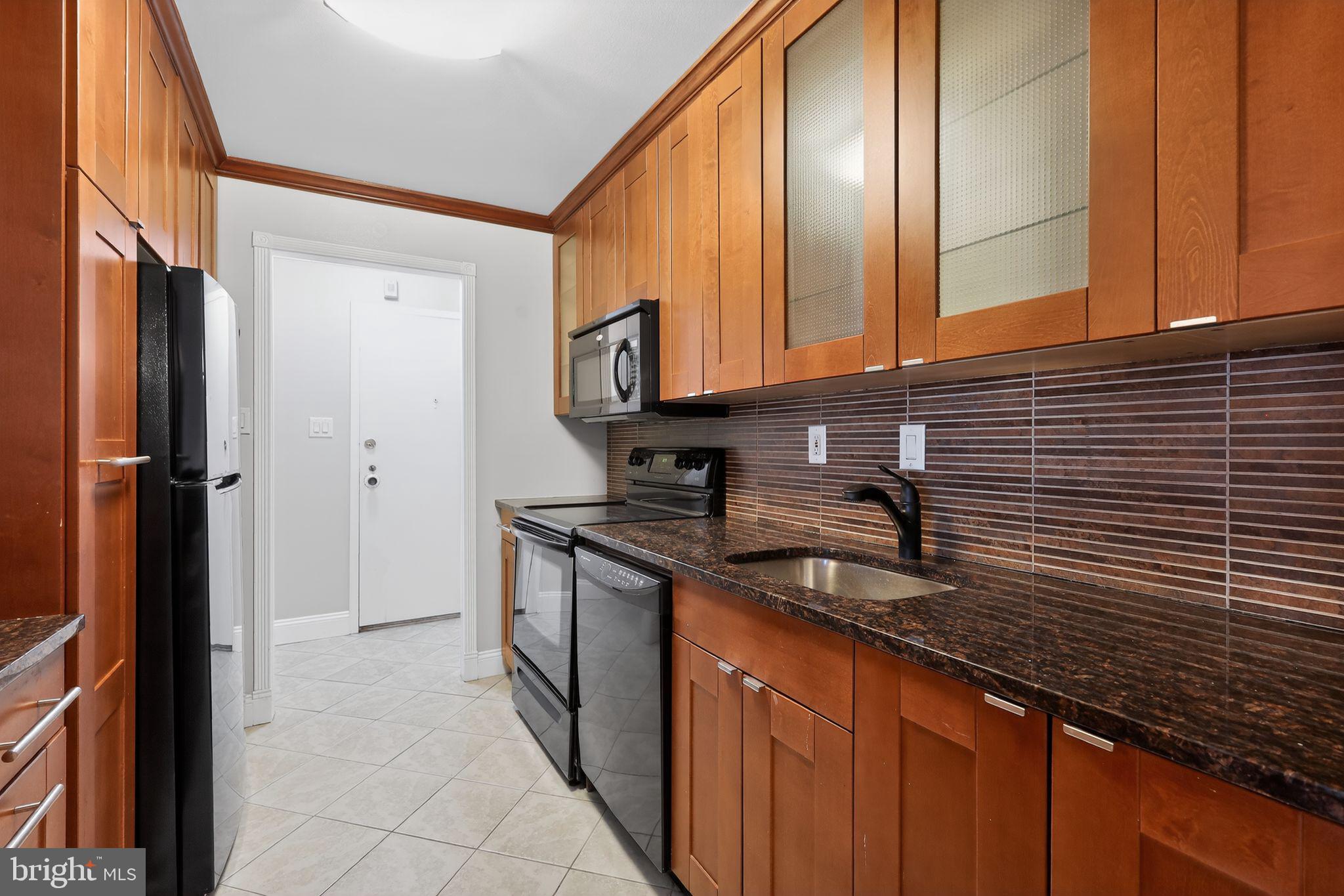 9701 Fields Road, Unit 1904 Gaithersburg, MD 20878 - Photo 16 of 31 a kitchen with stainless steel appliances granite countertop a sink and a cabinets