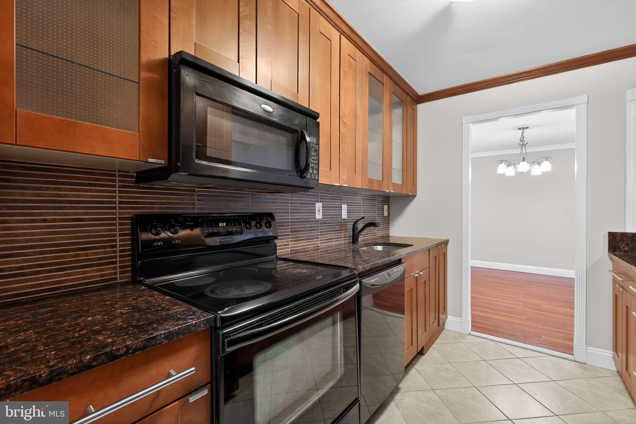9701 Fields Road, Unit 1904 Gaithersburg, MD 20878 - Photo 17 of 31 a kitchen with a stove microwave and sink