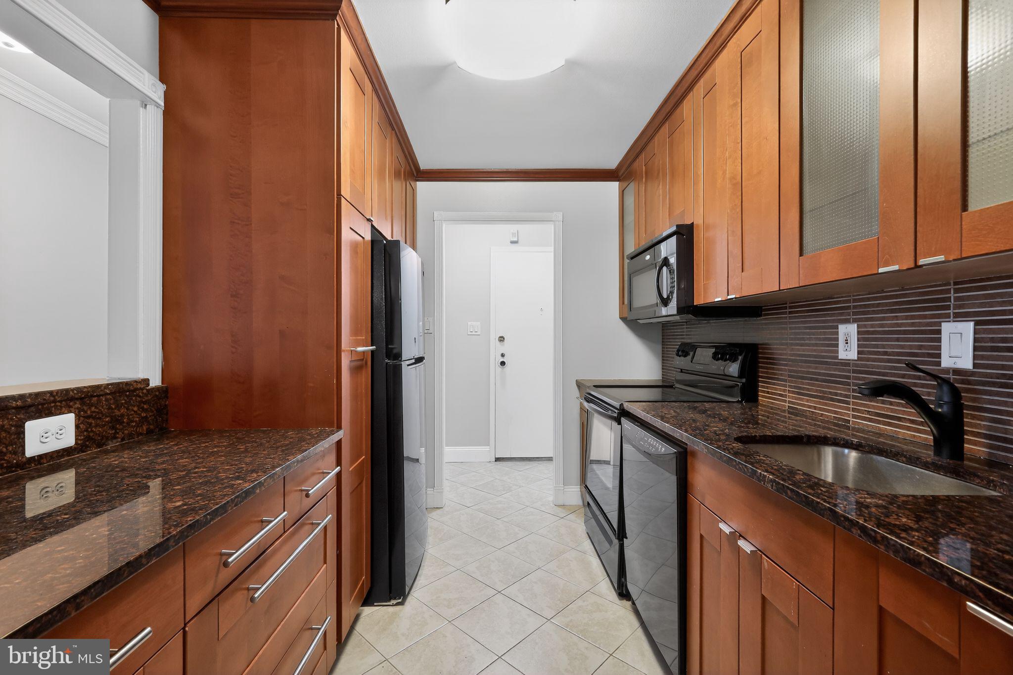 9701 Fields Road, Unit 1904 Gaithersburg, MD 20878 - Photo 18 of 31 a kitchen with stainless steel appliances granite countertop a sink and a stove