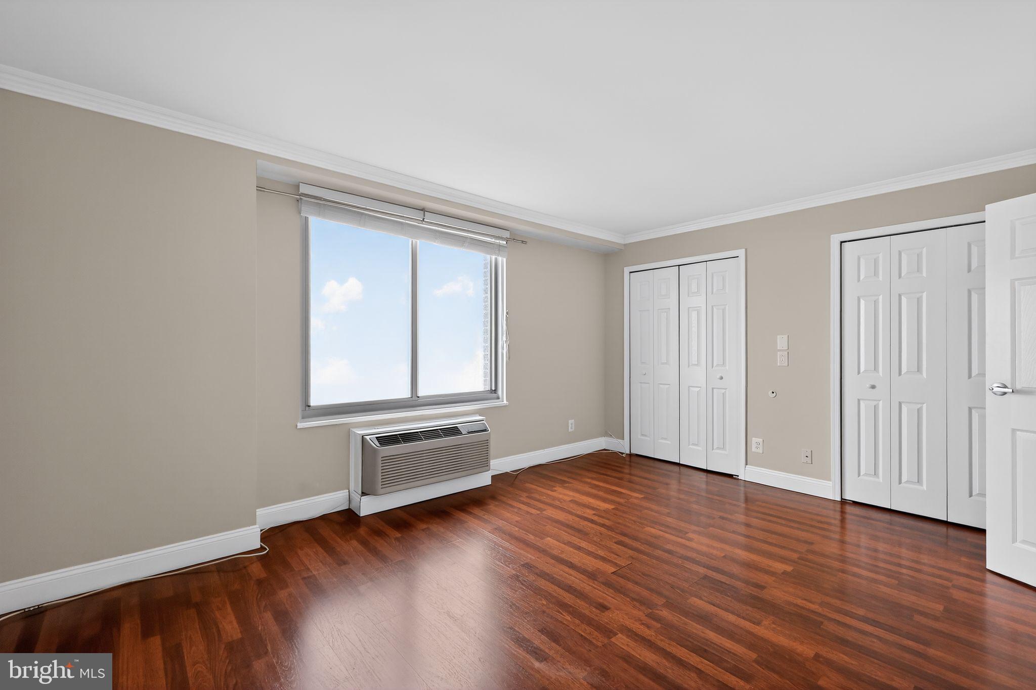 9701 Fields Road, Unit 1904 Gaithersburg, MD 20878 - Photo 23 of 31 a view of an empty room with wooden floor and a window