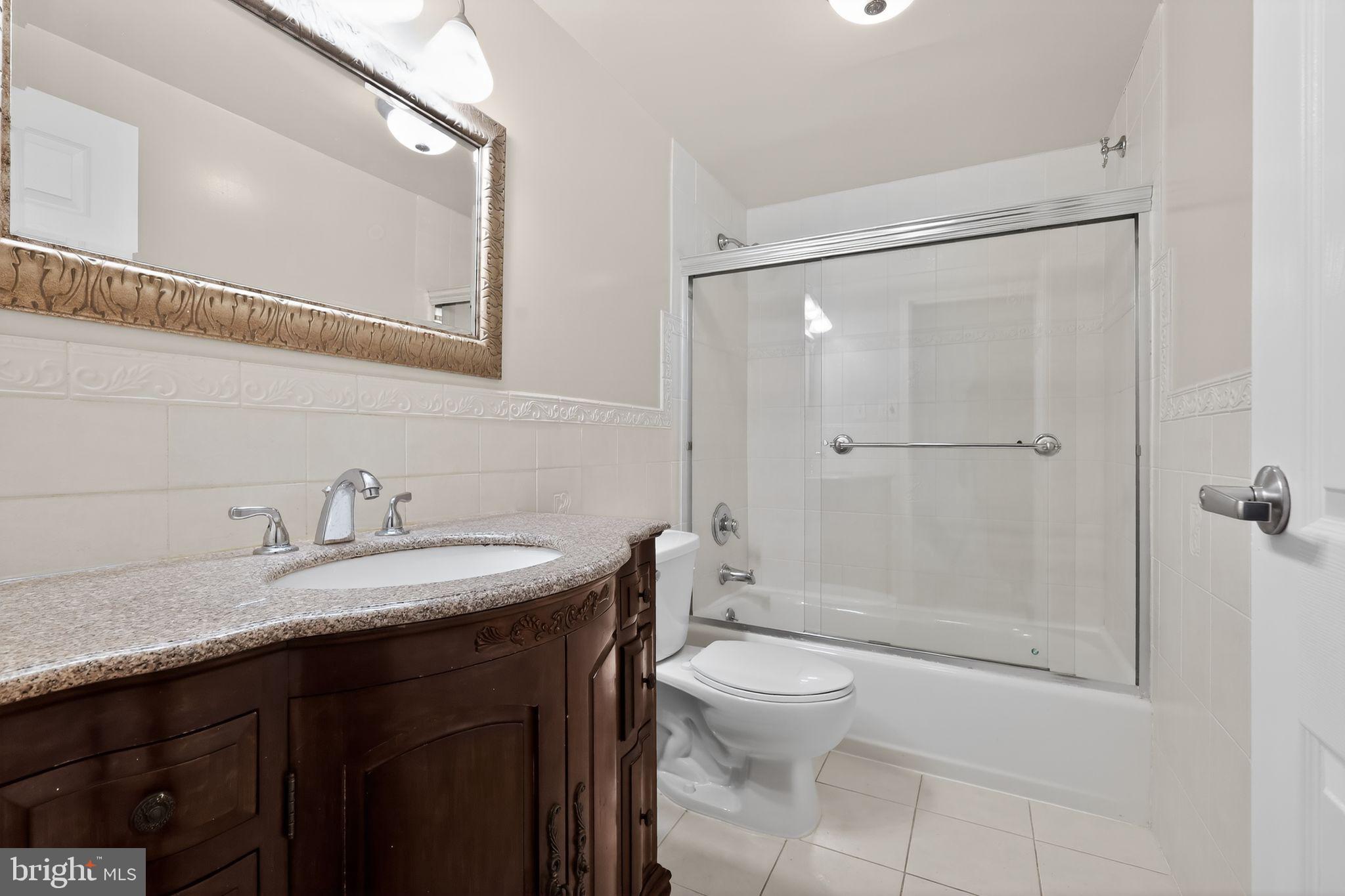 9701 Fields Road, Unit 1904 Gaithersburg, MD 20878 - Photo 25 of 31 a bathroom with a sink a toilet and shower