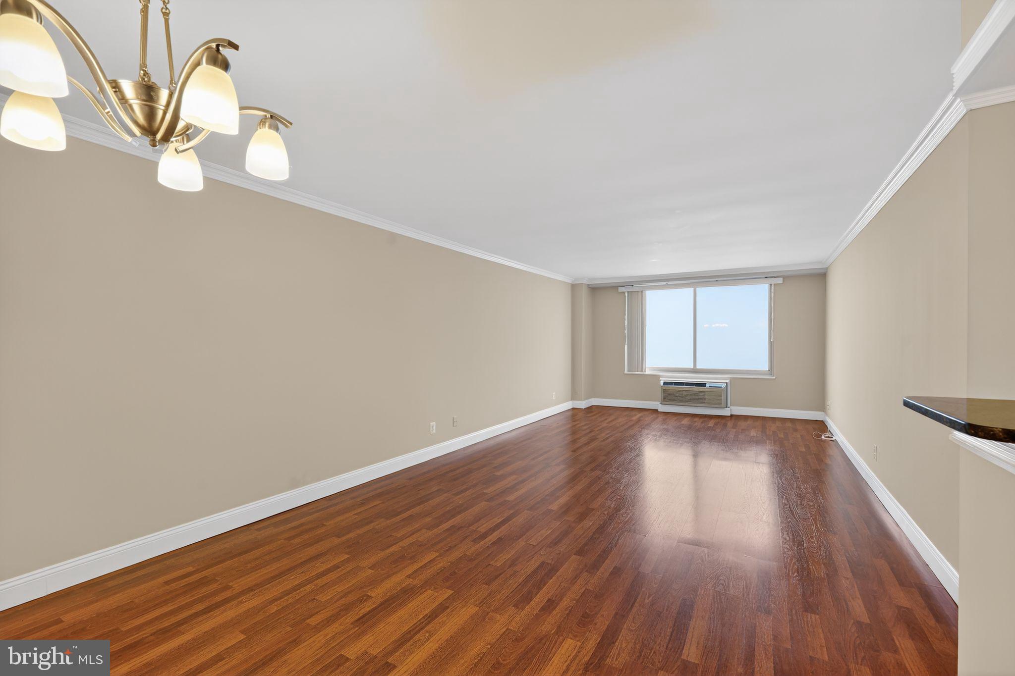 9701 Fields Road, Unit 1904 Gaithersburg, MD 20878 - Photo 8 of 31 a view of a room with wooden floor and window