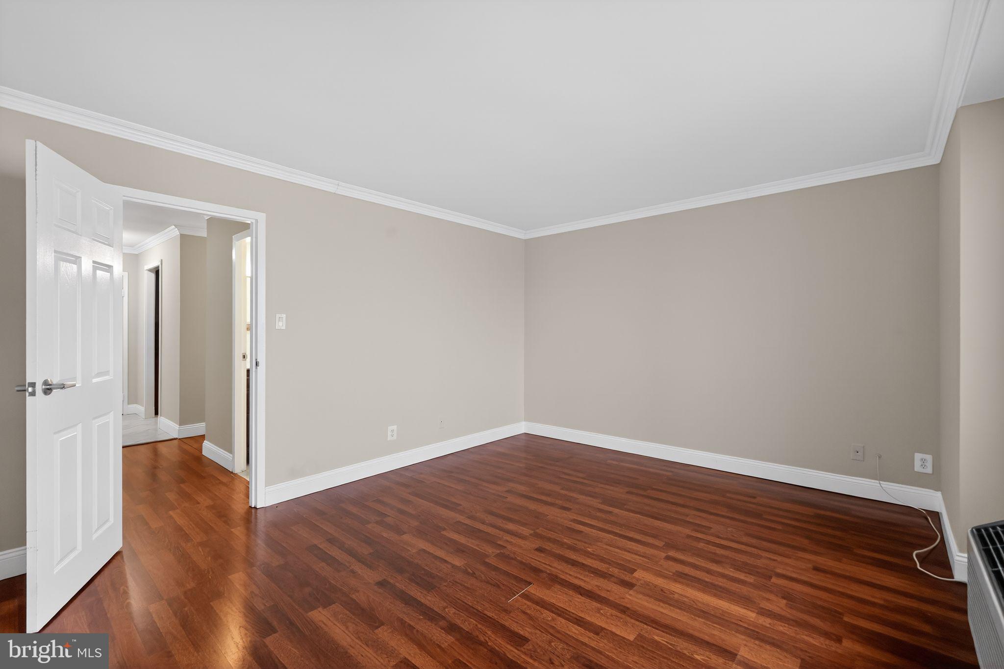 9701 Fields Road, Unit 1904 Gaithersburg, MD 20878 - Photo 9 of 31 a view of an empty room with wooden floor