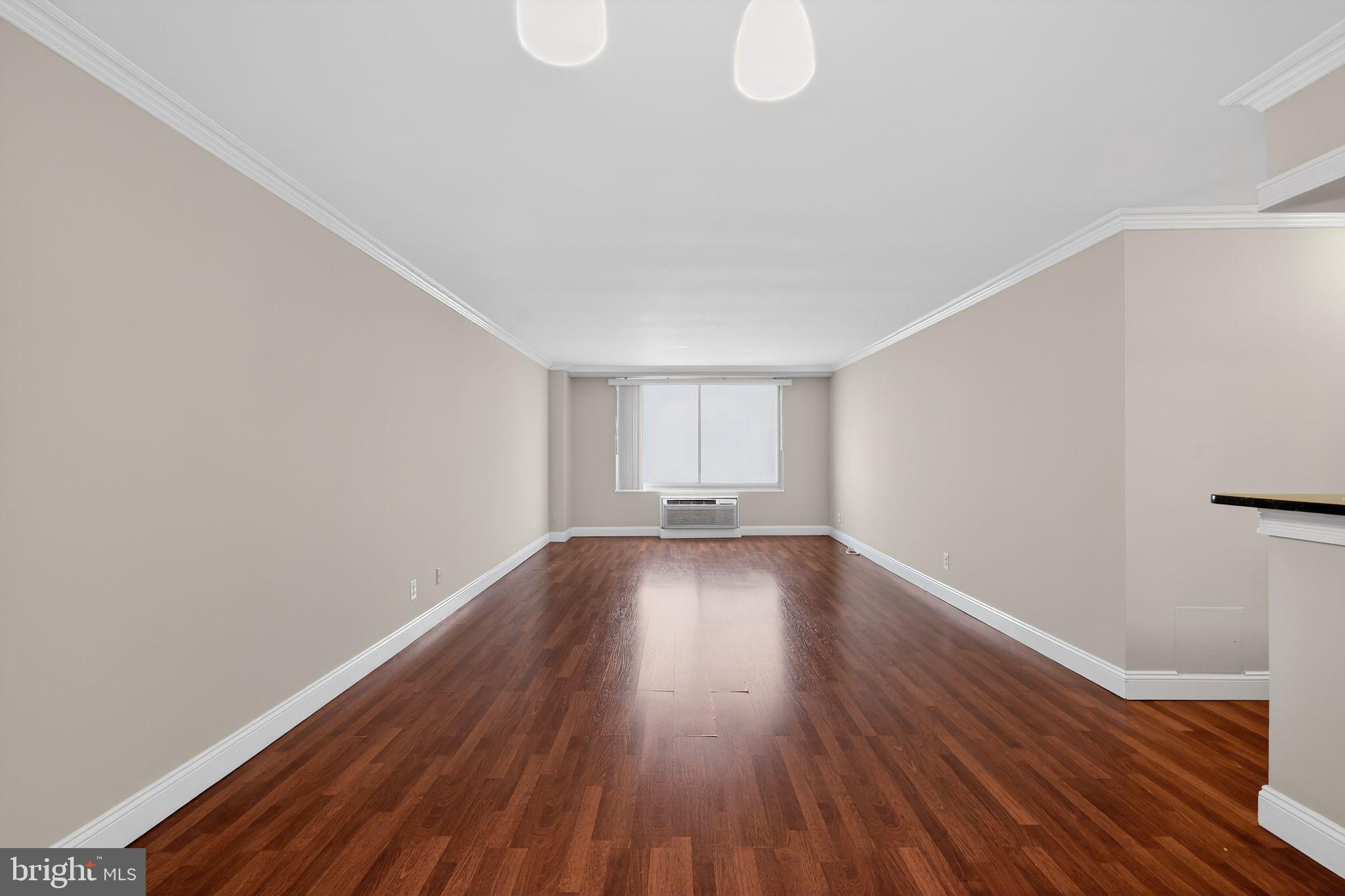 9701 Fields Road, Unit 1904 Gaithersburg, MD 20878 - Photo 10 of 31 a view of a room with wooden floor and white walls