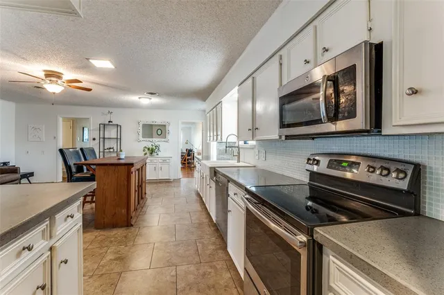a kitchen with cabinets appliances and a window