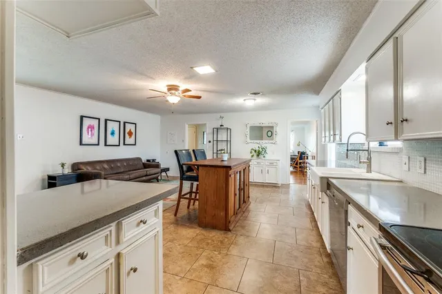 a kitchen with stainless steel appliances granite countertop a sink stove and cabinets