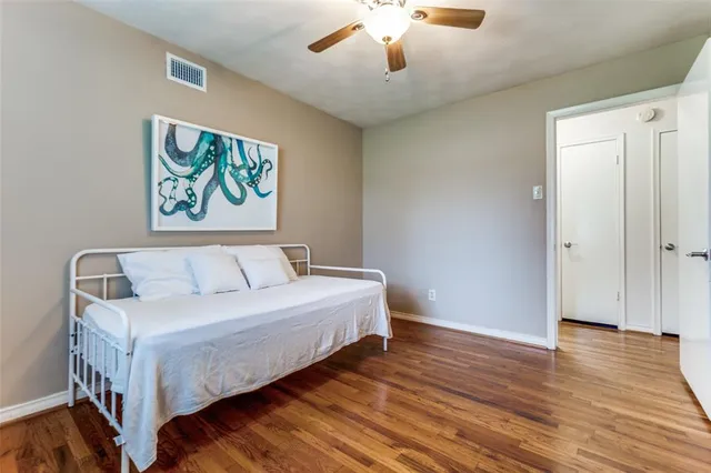 a workspace with wooden floor and a window