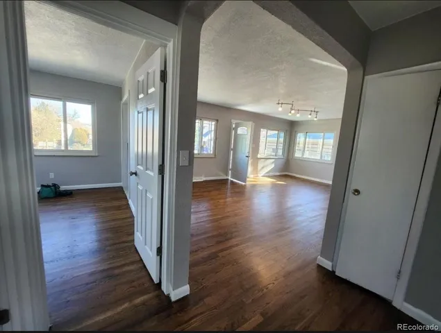 a bathroom with a sink a toilet a mirror and shower
