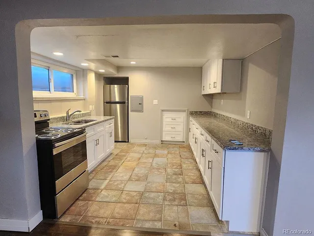 a bathroom with a sink mirror vanity and toilet