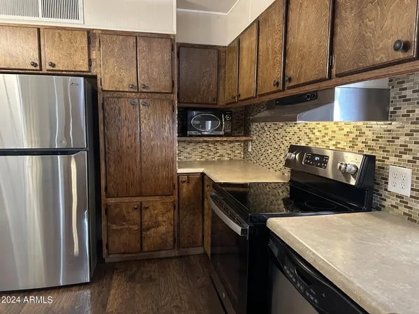 a kitchen with a refrigerator stove and cabinets