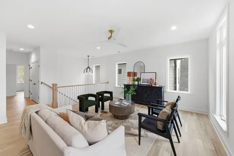 a living room with furniture and wooden floor