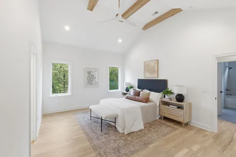 a bedroom with a bed and a window