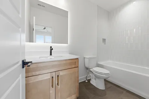 a bathroom with a sink toilet and shower