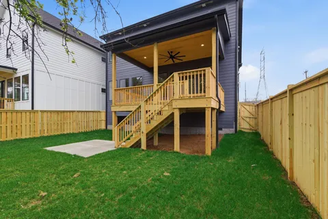 a view of house with backyard and deck