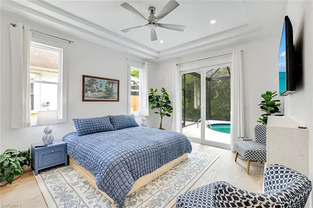 a bedroom with a large bed and a chandelier