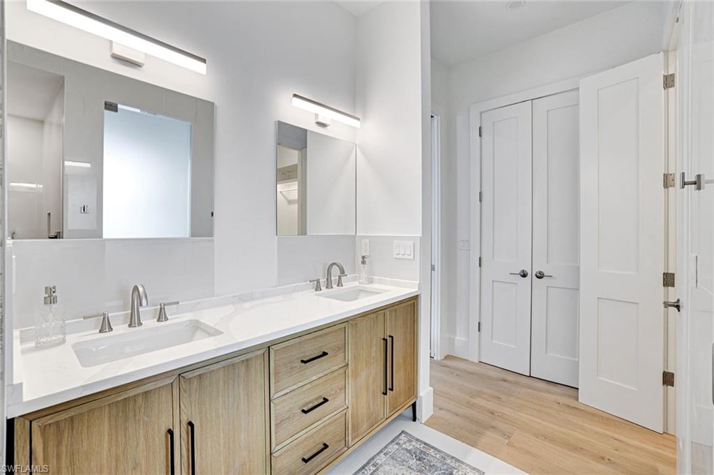 2515 Royal Palm Court Naples, FL 34103 - Photo 19 of 32 a bathroom with a sink and a mirror