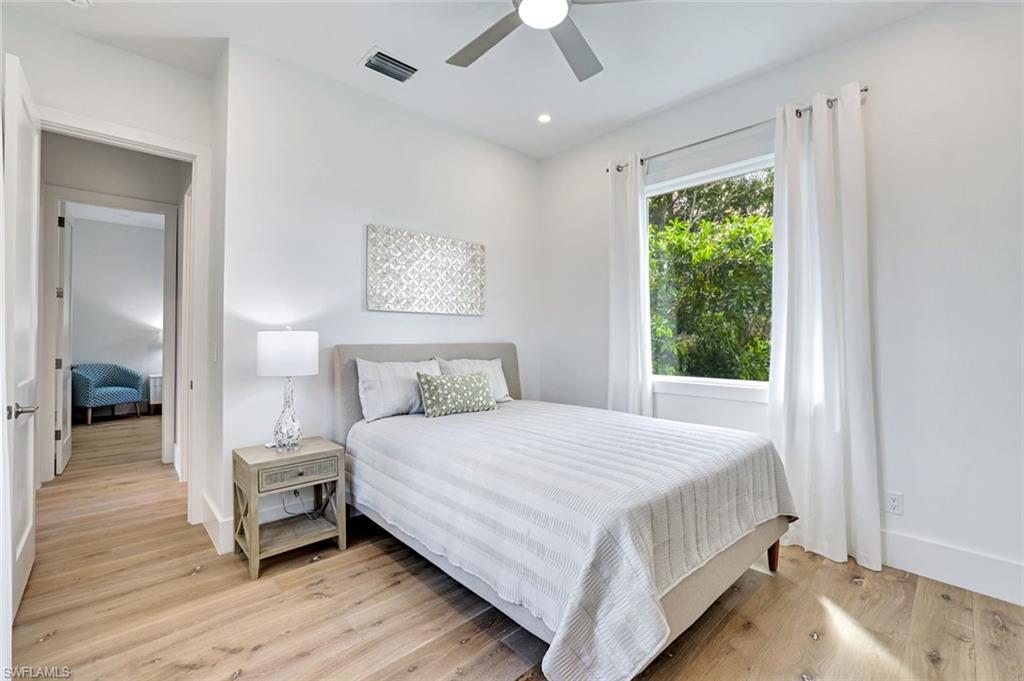 2515 Royal Palm Court Naples, FL 34103 - Photo 20 of 32 a bedroom with a bed and a window