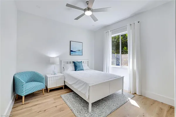 a bedroom with a bed couch and window