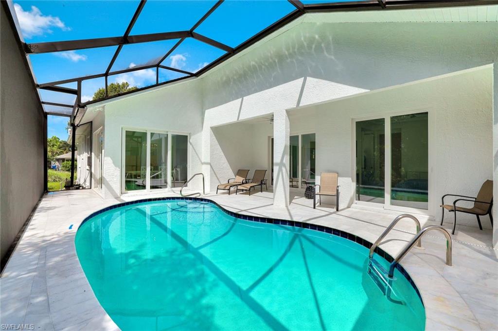 2515 Royal Palm Court Naples, FL 34103 - Photo 26 of 32 a swimming pool with outdoor seating and yard
