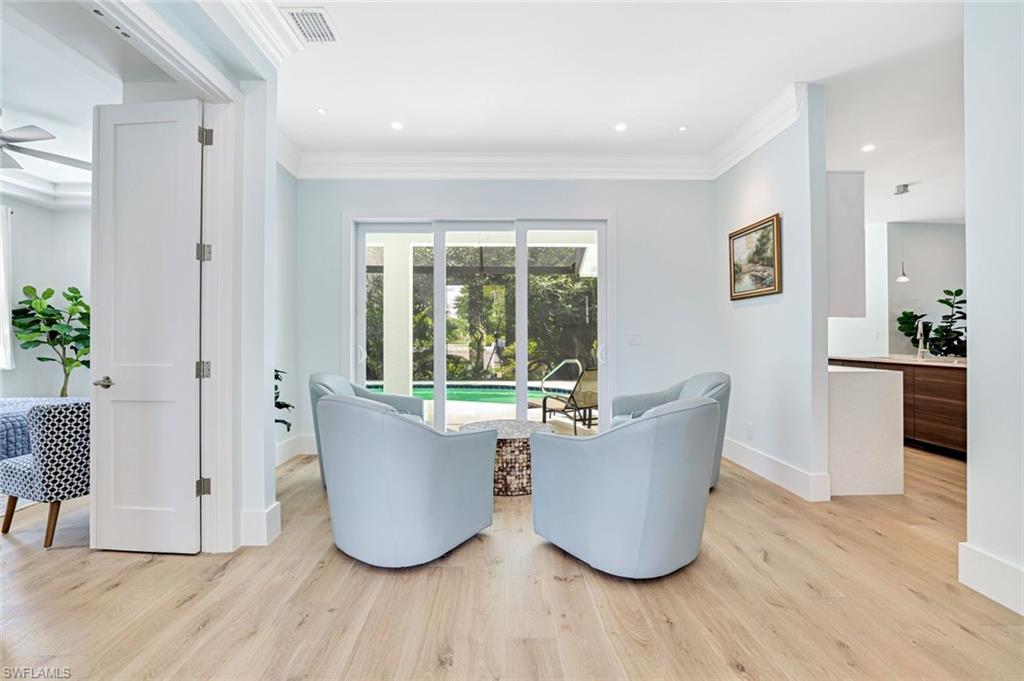 2515 Royal Palm Court Naples, FL 34103 - Photo 3 of 32 a living room with a couch and a potted plant