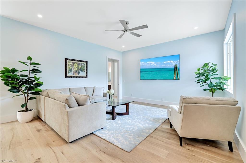 2515 Royal Palm Court Naples, FL 34103 - Photo 6 of 32 a living room with furniture and a potted plant