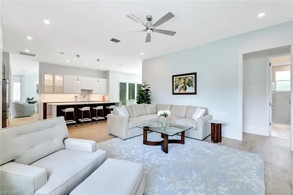 a living room with furniture and kitchen view