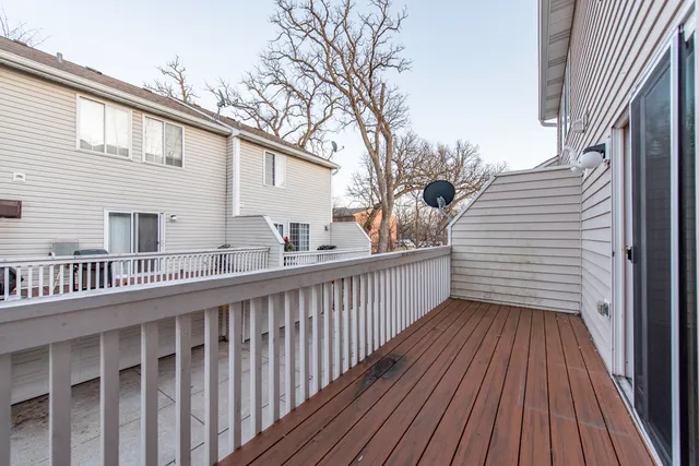 a view of a house with wooden deck