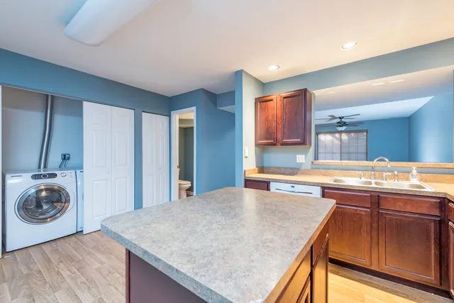 a kitchen with a sink a stove and cabinets