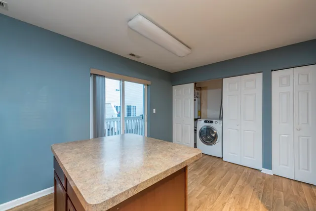 a view of a kitchen with a table and chairs