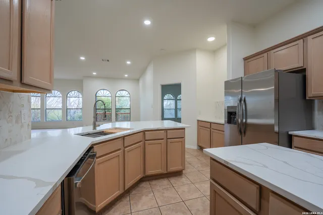a kitchen with a sink stainless steel appliances and cabinets