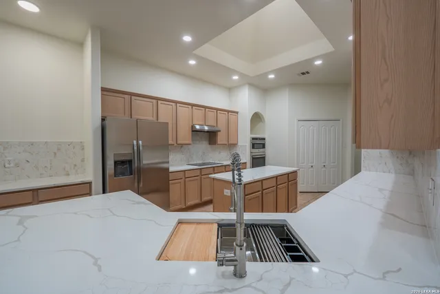 a kitchen with a sink and refrigerator