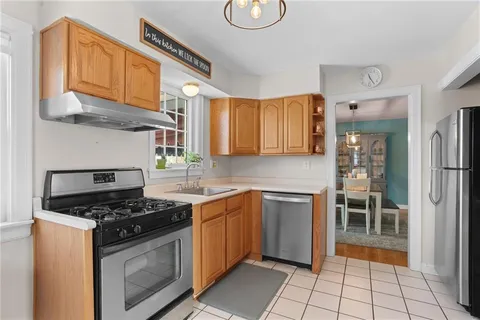 a kitchen with stainless steel appliances granite countertop a stove a sink and a refrigerator
