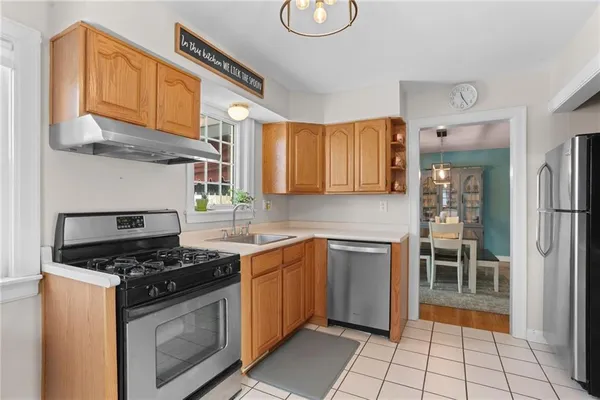 a kitchen with stainless steel appliances granite countertop a stove a sink and a refrigerator