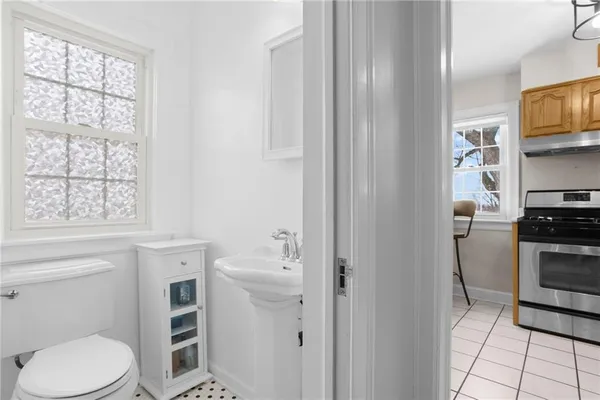 a bathroom with a sink a toilet and window