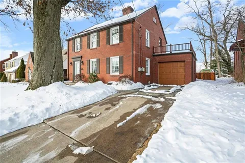 a view of a house with snow on the road