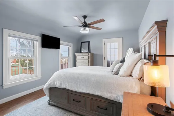 a bedroom with a large bed and a window