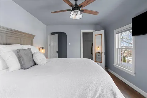 a bedroom with a bed and a chandelier