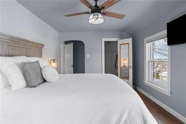 a bedroom with a bed and a chandelier