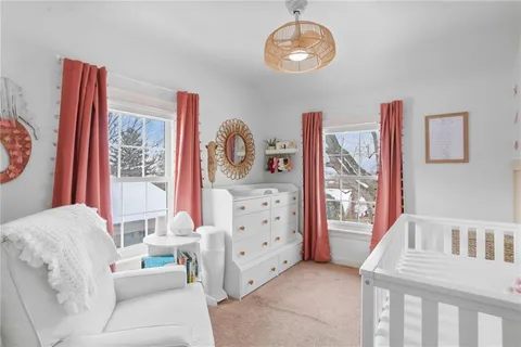 a bedroom with furniture and a baby crib