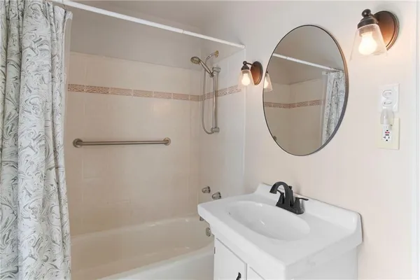 a bathroom with a sink a toilet and a window