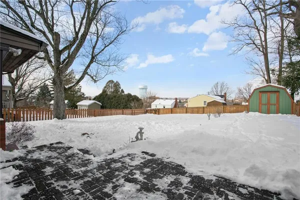 a view of a house with a yard covered in snow