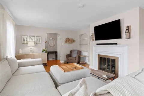 a living room with fireplace furniture and a flat screen tv